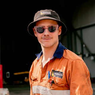 Harps safety glasses with pink frame and grey polarised lens, front view